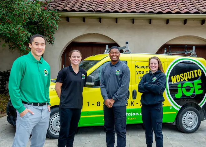 Picture of Mosquito Joe Team in front of Mosquito Joe vans.