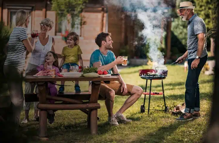 Family enjoying a backyard gathering in Melbourne, FL after reducing nuisance gnats and no-see-ums around outdoor living spaces.