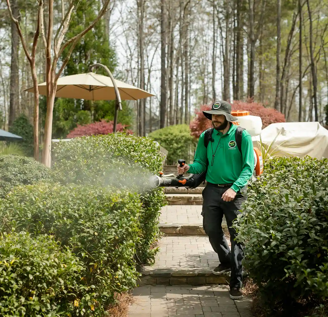 Mosquito Joe technician spraying garden.