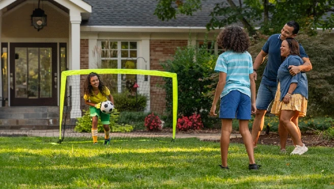 Family playing soccer.