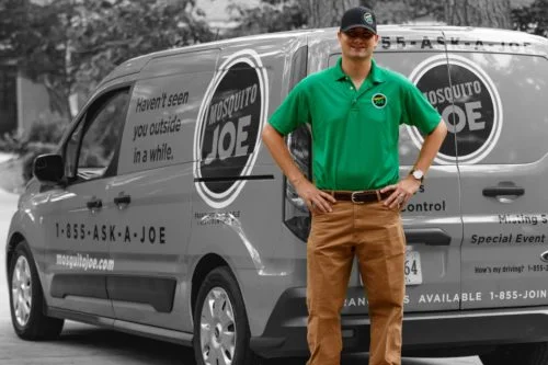 Mosquito Joe professional standing in front of company truck