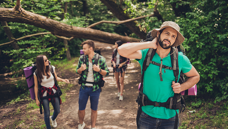 Group of friends hiking and getting bitten by bugs.