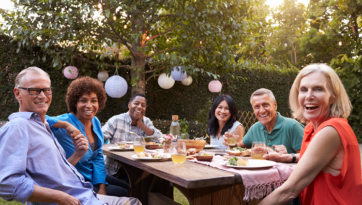 A picture of a group of people enjoying a meal outdoors.