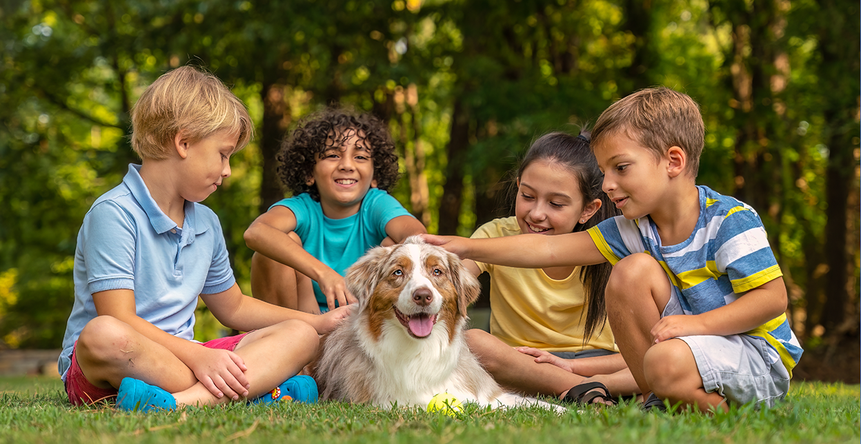 Kids petting their dog.