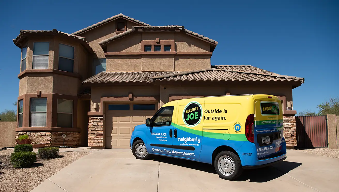 Mosquito Joe van in front of a house.