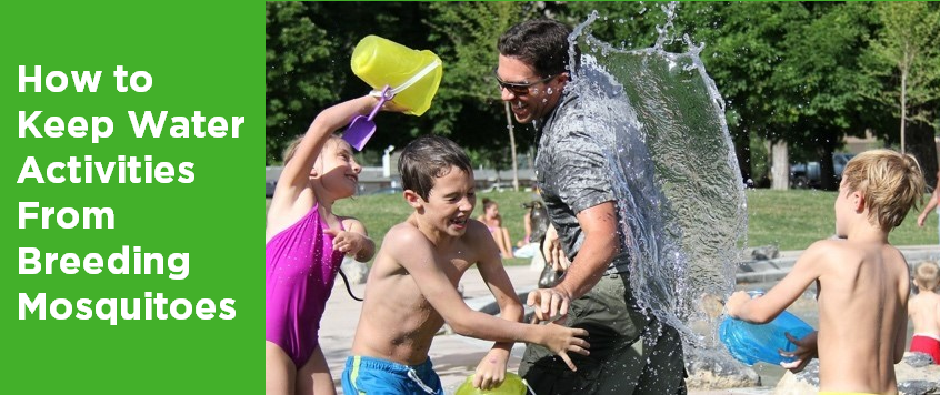 Family playing with water buckets outdoors.