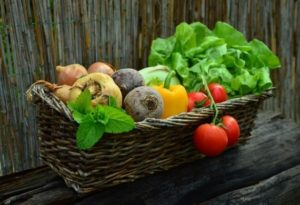 A basket with full of vegetables.