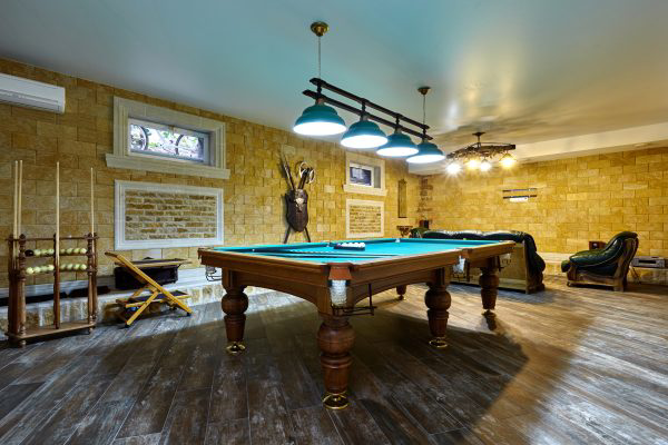 Finished basement with pool table.