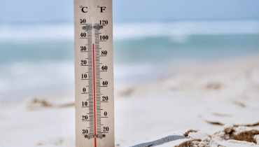 Thermometer on the beach sand.