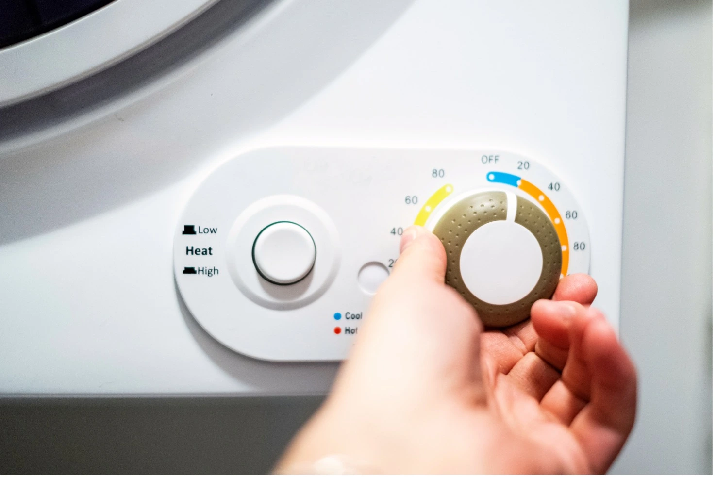 Dryer machine heat knob being turned up